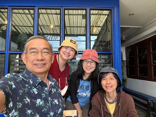 a group of people standing in front of a building at Chiangmai HomeTeL in Chiang Mai