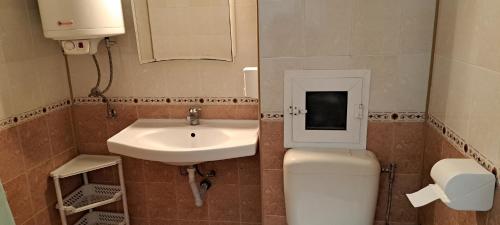a small bathroom with a toilet and a sink at ПРИНЦЕС in Burgas City