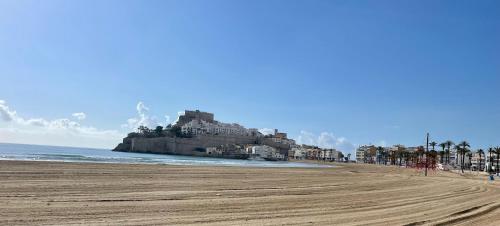 a view of a beach with a castle in the distance at Loft Time - Somhome in Peniscola