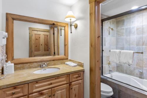 a bathroom with a sink and a shower and a toilet at Telluride Mountain Lodge Skiin Out amazingLocation in Telluride