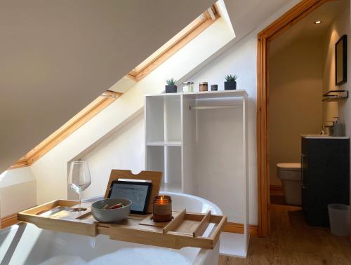 a room with a table with a laptop on it at Mini-studio by HNFC Stays in South Shields