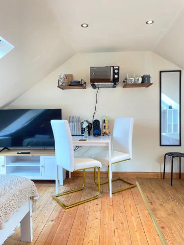 a room with a desk and two white chairs at Mini-studio by HNFC Stays in South Shields