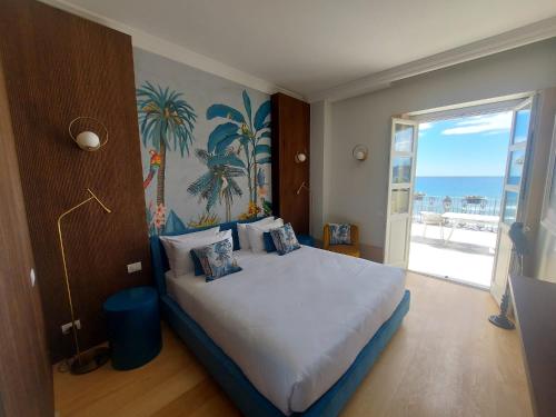 a bedroom with a bed with a view of the ocean at Grand Hotel Alassio Beach & Spa Resort - The Leading Hotels of the World in Alassio