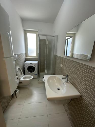 a bathroom with a sink and a toilet at Be Chic in Alba Adriatica