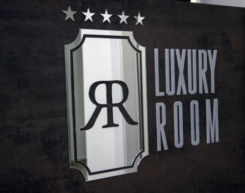 a sign for a library room with the rx logo at LAURIA Luxury Room in Gela