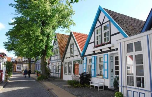 a row of houses with people walking down a street at Birnbom Warnemünde in Warnemünde