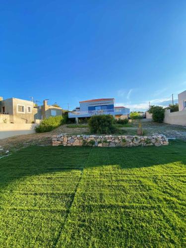 a large yard with a building in the background at The Dona House in Vaia