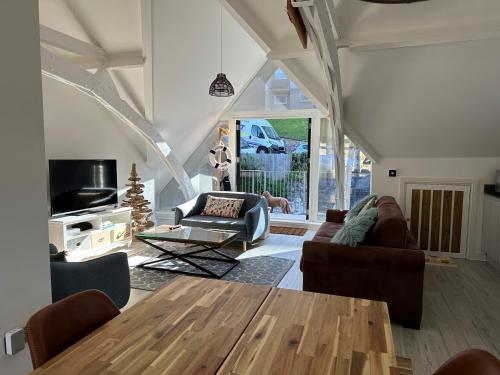 a living room with a table and chairs at Beautiful, spacious 3 bed Brixham apartment in Brixham