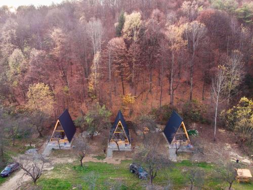 an aerial view of three tents in a forest at Pensiunea Agroturistica Cerna, Vaideeni - Polovragi in Vaideeni