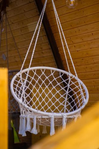 a white basket hoop hanging from a ceiling at Pensiunea Agroturistica Cerna, Vaideeni - Polovragi in Vaideeni