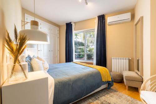a bedroom with a bed and a window at Marachique Villa - Torralvor in Alvor