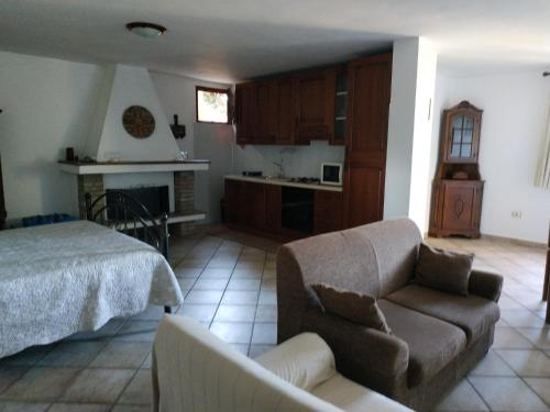 a living room with a bed and a couch at Casa con vista sul golfo vicina al mare in Santa Luria
