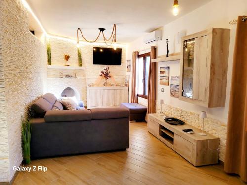 a living room with a couch and a tv at Villa Tore in Quartu SantʼElena