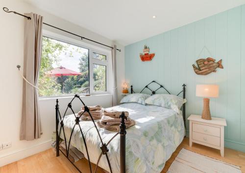 a bedroom with a bed and a window at Little Glebe in Middleton