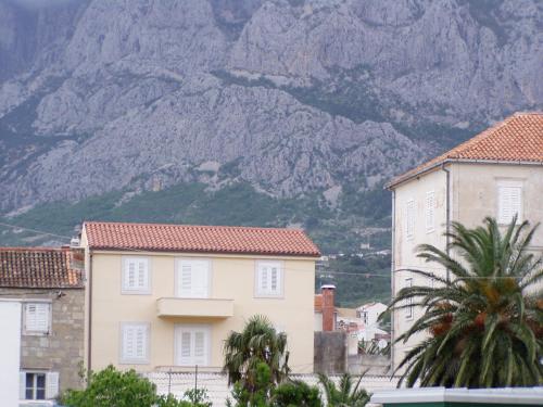 a house with a mountain in the background at Luxury Apartment Spa "Marina" in Makarska