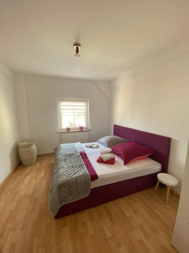 una camera da letto con un grande letto con cuscini rossi di Geräumiges Stadtapartment a Lichtenstein