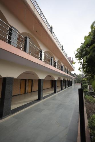an empty building with a balcony on the side at Hotel Mukund Dham-Near Mathura Railway Station in Mathura