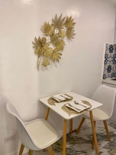 a table and two chairs in a room at MAKATI Isabela Luxury in Manila