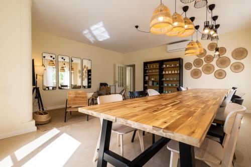 a dining room with a wooden table and chairs at Marachique Villa - Torralvor in Alvor