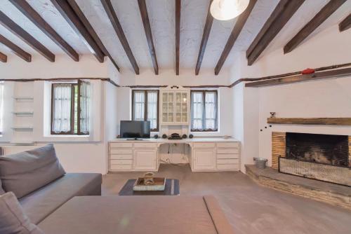 a living room with a couch and a fireplace at Villa Nefeli in Sani Beach