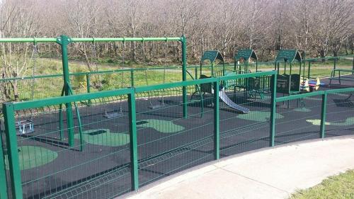 a park with a playground with a slide at The Derg Arms B&B in Castlederg