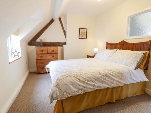 a bedroom with a large bed and a window at Tolldish Cottage in Stafford
