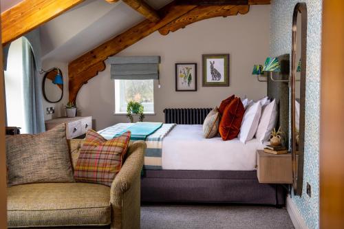 a bedroom with a bed and a couch at The Red Lion & Manor House in Burnsall