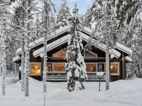 a log cabin in the woods in the snow at Holiday Home Ansa by Interhome in Sirkka