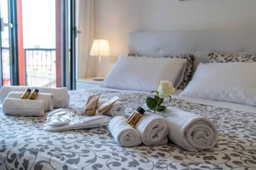a bedroom with a bed with towels on it at Charme in Porta Palio - City Center in Verona