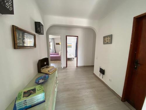 a living room with a table and a room with a couch at Guest House Casa Ramos on the Strip in Albufeira