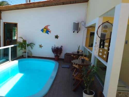 a swimming pool in the middle of a room with a balcony at Pousada Aconchego do Maraca in Porto De Galinhas