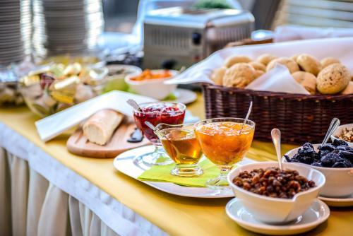 a buffet of food with bread and drinks on a table at Hotel Belweder in Ustroń