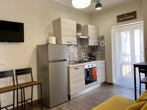 a kitchen with a refrigerator and a stove top oven at Casa Vacanze Fontana Fraterna in Isernia