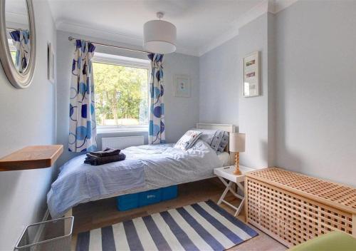 a small bedroom with a bed and a window at Number Eight in Westleton