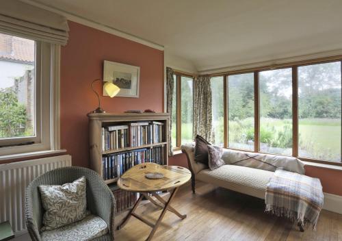 a living room with a couch and chairs and a table at Old Farm in Walberswick