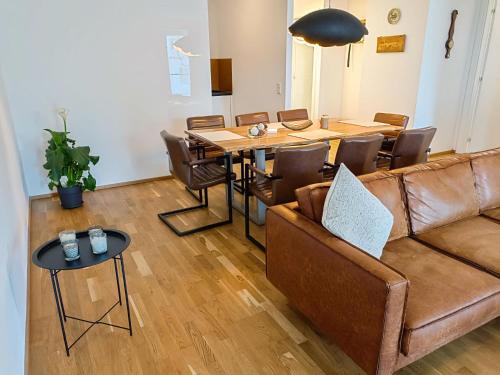 a living room with a couch and a table and chairs at Apartment Luxury Sunrise Appartement by Interhome in Pörtschach am Wörthersee