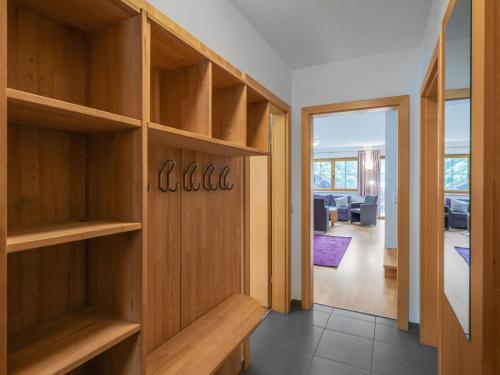 a room with wooden shelves and a living room at Chalet Pflaume by Interhome in Bad Gastein