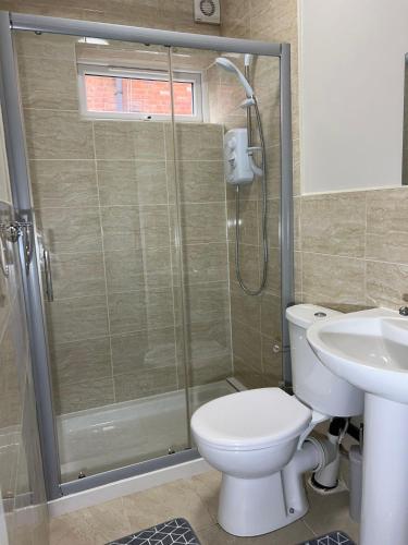 a bathroom with a shower and a toilet and a sink at Apt 3. Private Studio in Moseley, Birmingham in Birmingham