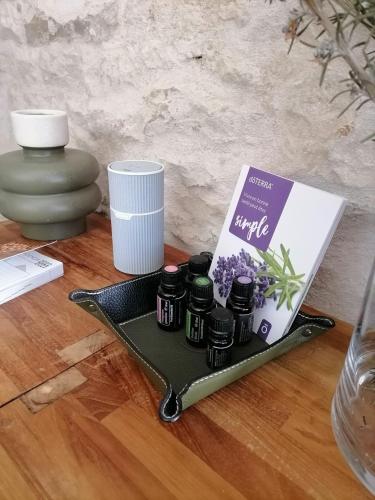 a tray with a book and some spices on a table at Studio 2 à 4 personnes in Dompierre-sur-Mer