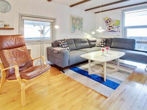 a living room with a couch and a table at Holiday Home Igilfar - 700m from the sea in Western Jutland by Interhome in Vejers Strand