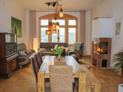 a living room with a table and a fireplace at Apartment Villa am Großen Garten by Interhome in Dresden