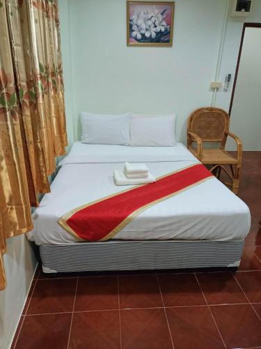 a bedroom with a bed with two towels on it at Kata S.T House 2 in Phuket