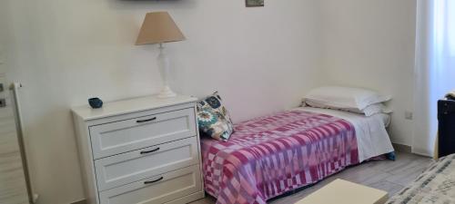 A bed or beds in a room at La Casetta di Meta