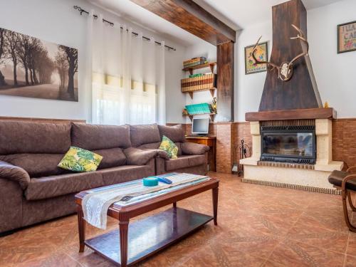 a living room with a couch and a fireplace at Holiday Home San Fernando by Interhome in Villanueva del Río y Minas