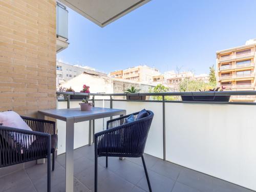 a table and chairs on a balcony with a view at Apartment Barcelona by Interhome in Torredembarra