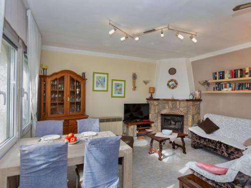 a living room with a table and a fireplace at Villa Villa Resi by Interhome in Miami Platja