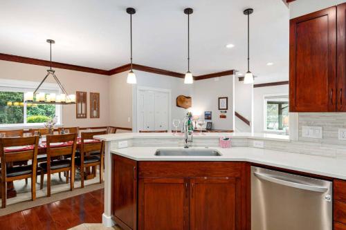 a kitchen with a sink and a dining room at Otter Banks in Florence