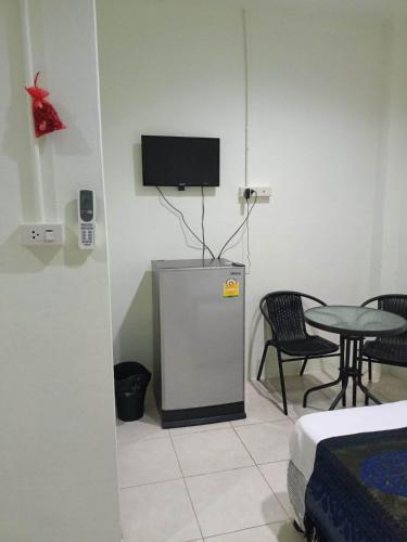 a room with a small refrigerator and a table at Kata S.T House 2 in Phuket
