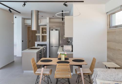 a kitchen and dining room with a table and chairs at La Villa del Mare - Nafpaktos Beach in Nafpaktos