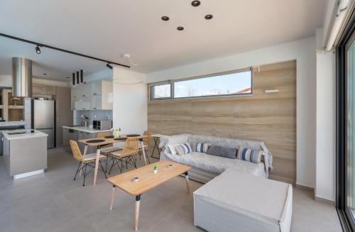a living room with a couch and a table at La Villa del Mare - Nafpaktos Beach in Nafpaktos